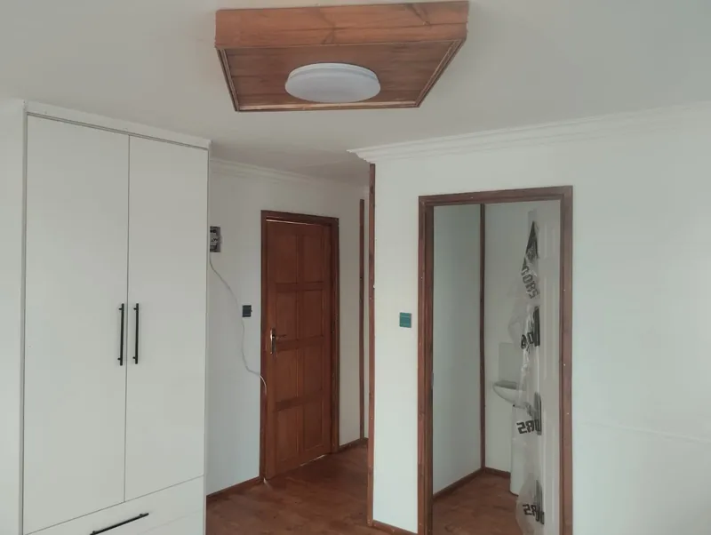 Bedroom with a built-in wardrobe and wood-look floor