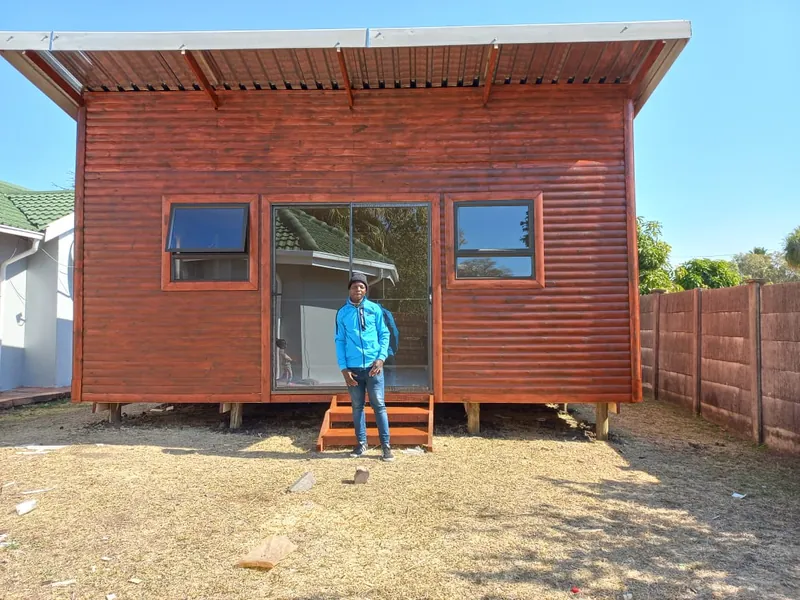 Timber cabin with a mono-pitch roof and sliding door