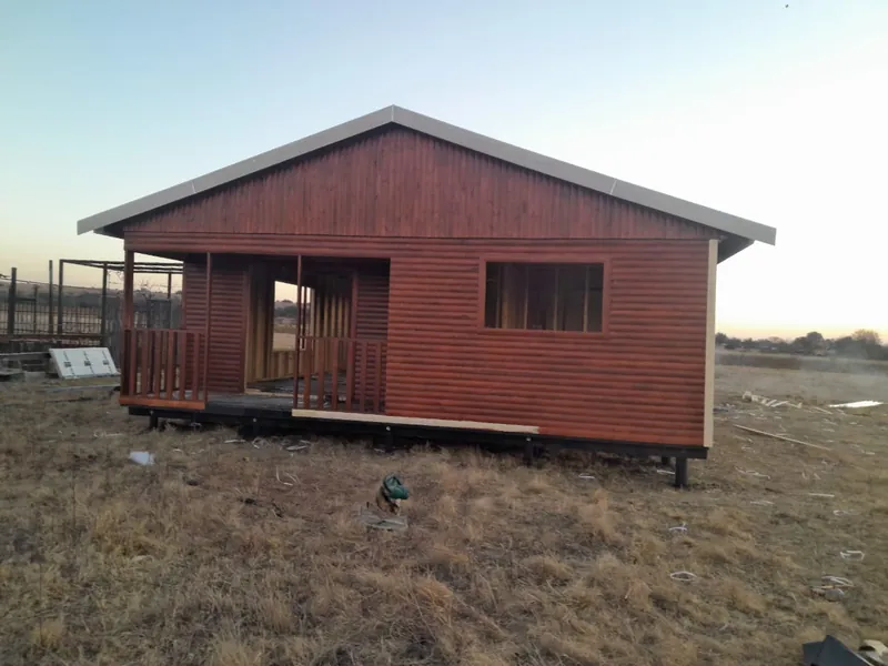 Red-stained timber home with a covered veranda