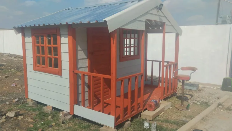 Grey Nutec Wendy house with red trim and a small porch